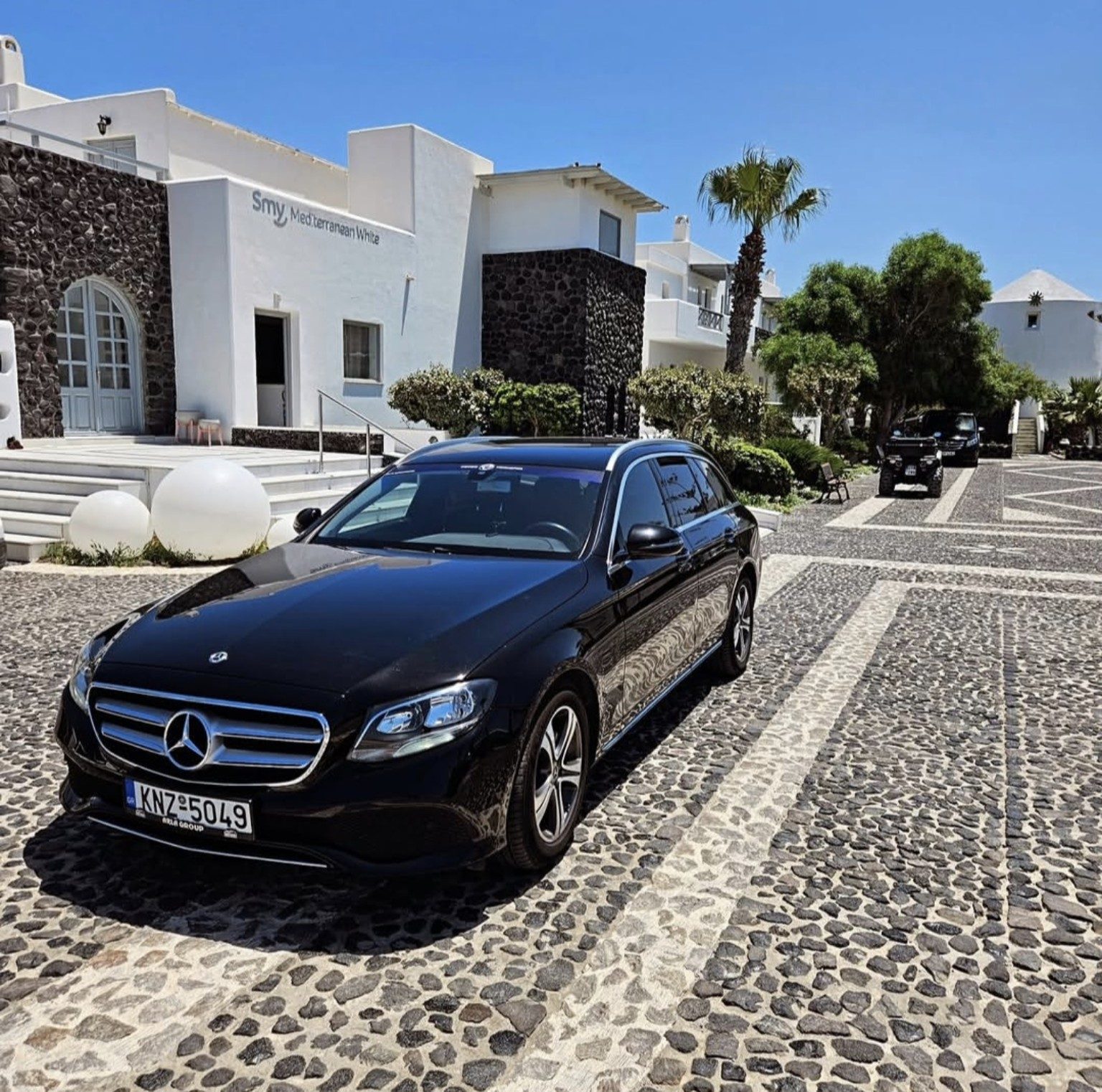 Black Mercedes-Benz E-Class parked at a hotel in Santorini